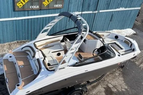 Slide: The Image of 2023 Yamaha Boats 195S, sleek design, spacious interior, docked outdoors. - 7