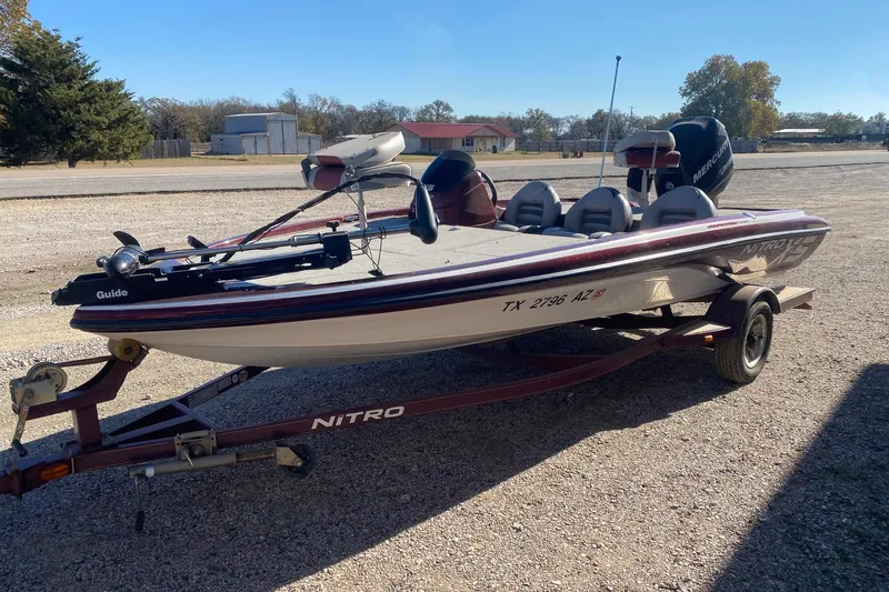 Slide: The Image of 2009 Nitro X-5 boat on trailer, parked outdoors, featuring a sleek design and multiple seats. - 3