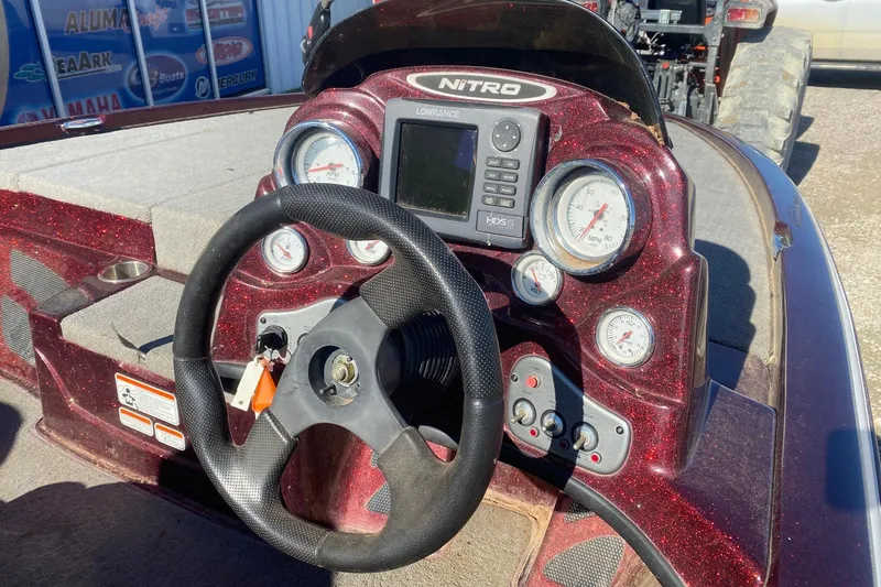 Slide: The Image of Dashboard of a 2009 Nitro X-5 boat with steering wheel and gauges. - 7