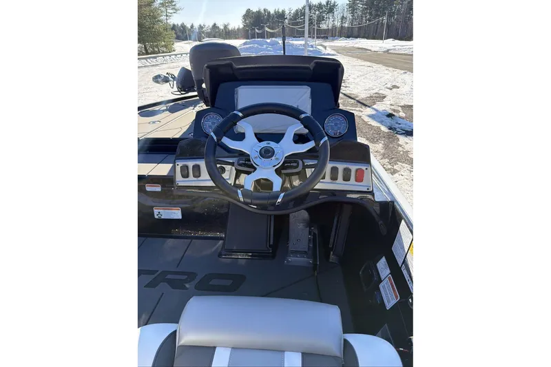 Slide: The Image of 2026 Nitro Z19 XL Pro boat dashboard with steering wheel and gauges in snowy setting. - 5