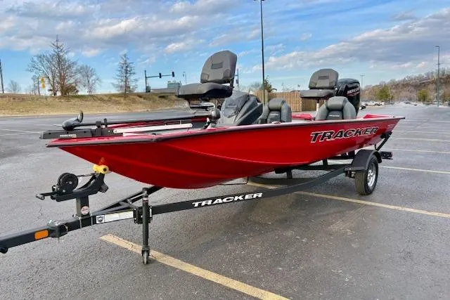 Slide: The Image of 2026 Tracker Pro Team 175 boat in a parking lot, featuring a vibrant red design. - 76