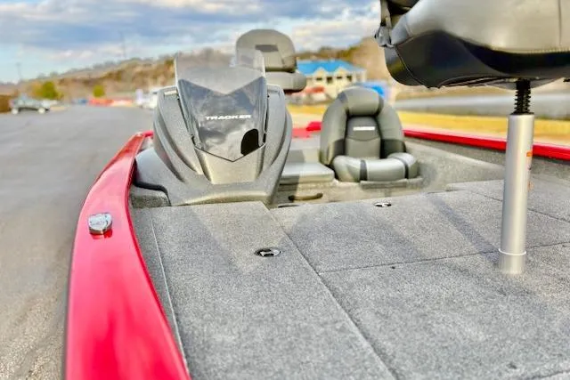 Slide: The Image of 2026 Tracker Pro Team 175 boat, red, parked by a river with Mercury engine. - 77