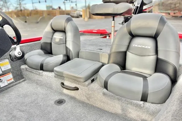 Slide: The Image of 2026 Tracker Pro Team 175 boat with Mercury engine, parked near a river. - 78