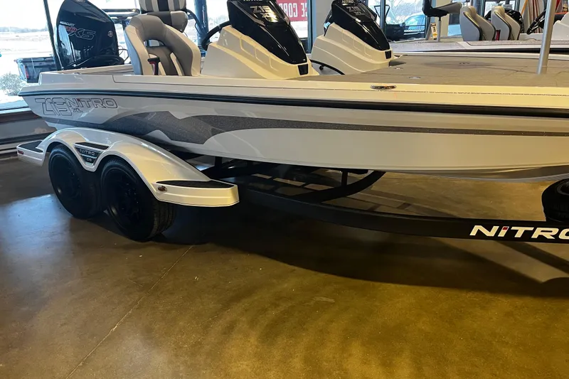The Image of 2026 Nitro Z19 XL Pro boat on display in showroom, featuring sleek design and dual engines. - 0