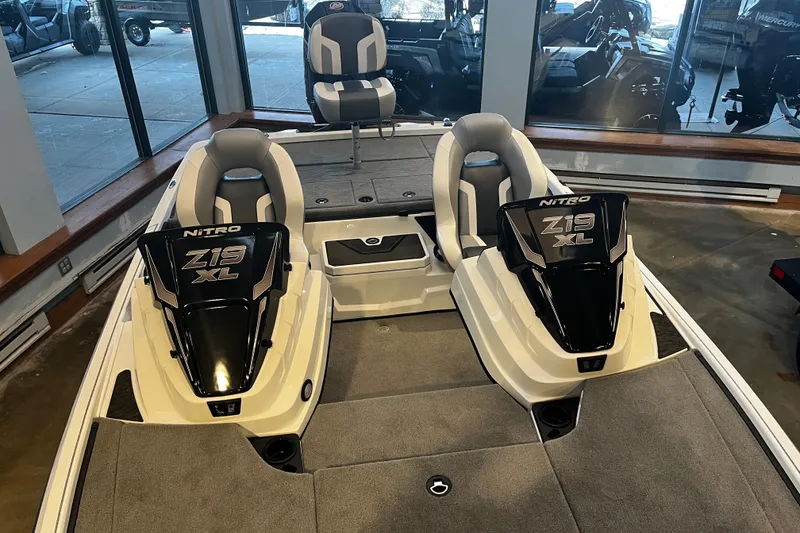 Slide: The Image of 2026 Nitro Z19 XL Pro boat on display, featuring sleek design and dual-axle trailer. - 88