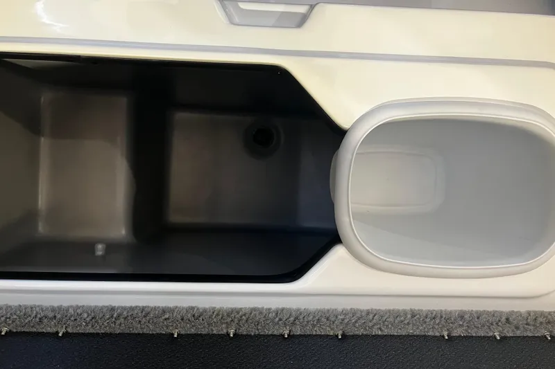 Slide: The Image of 2026 Nitro Z19 XL Pro boat storage compartment with carpeted edge and sleek design. - 90