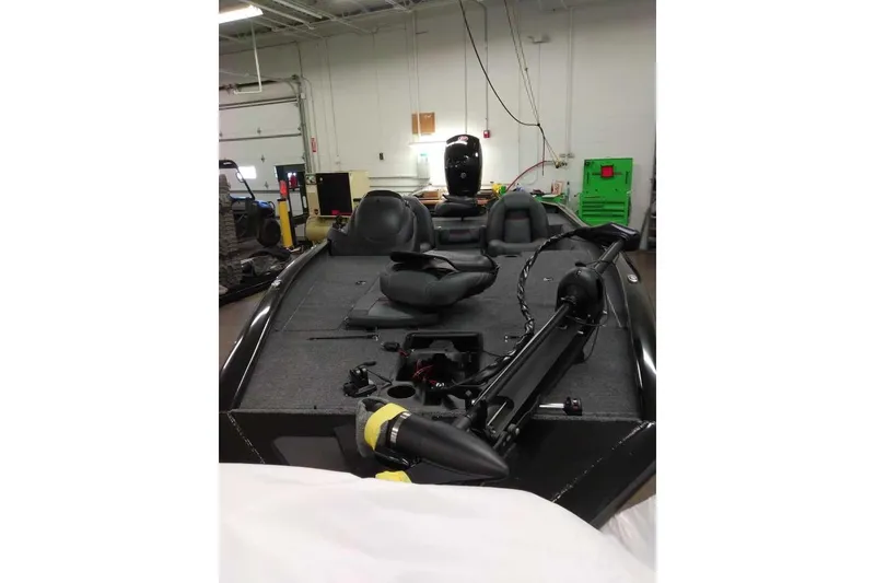 Slide: The Image of 2026 Tracker Pro Team 195 boat in a garage, featuring seating and equipment. - 2