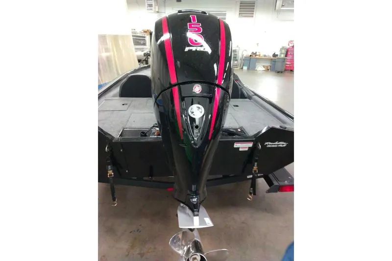 Slide: The Image of 2026 Tracker Pro Team 195 boat with powerful 150 HP engine in a workshop setting. - 3