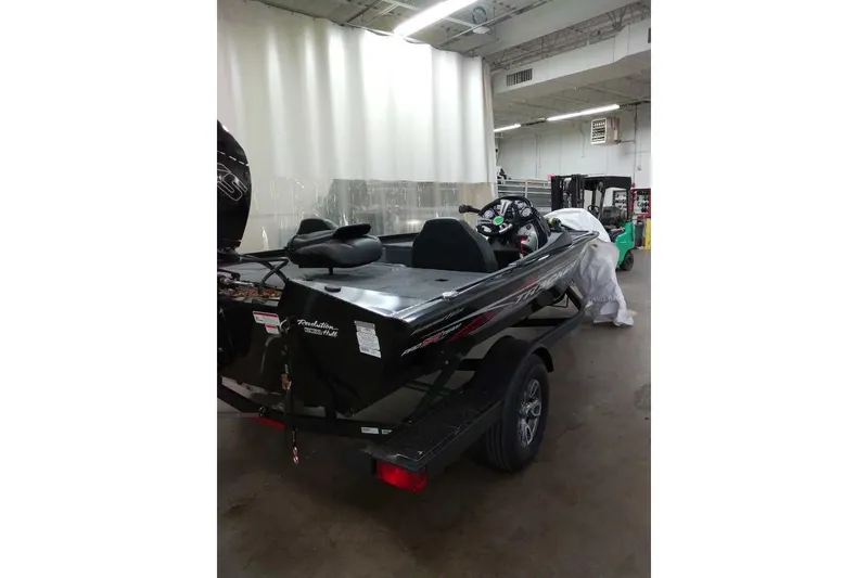 Slide: The Image of 2026 Tracker Pro Team 195 boat in a warehouse setting, rear view. - 57