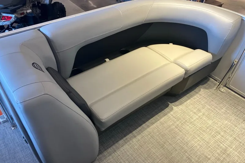 Slide: The Image of 2026 Sun Tracker Party Barge 18 DLX interior seating with gray upholstery and cup holders. - 4