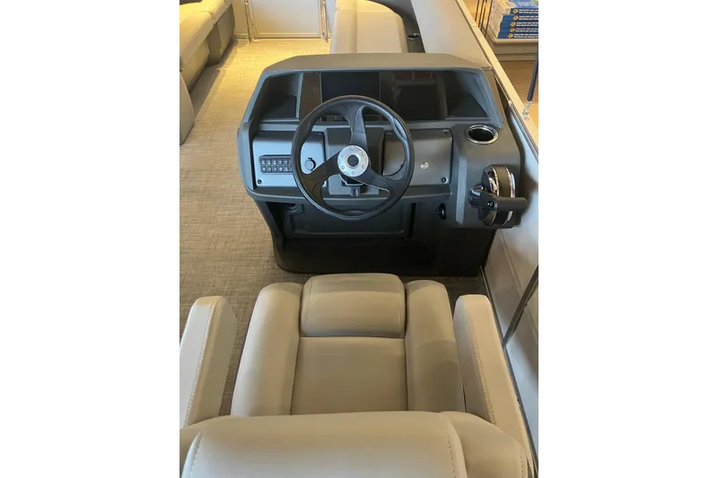 Slide: The Image of 2026 Sun Tracker Party Barge 18 DLX helm with steering wheel and controls. - 8
