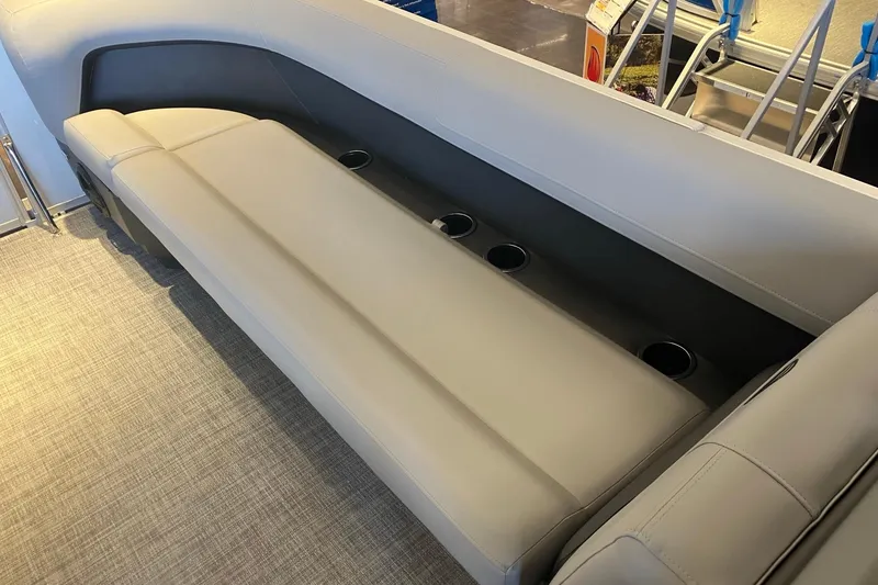 Slide: The Image of 2026 Sun Tracker Party Barge 18 DLX interior seating with cup holders, showcasing luxury and comfort. - 5