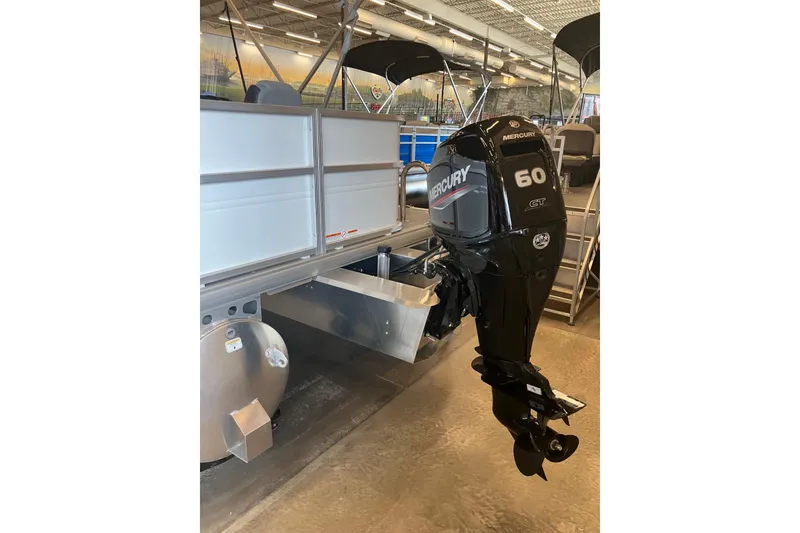 Slide: The Image of 2026 Sun Tracker Party Barge 18 DLX with Mercury 60 outboard motor in showroom. - 1