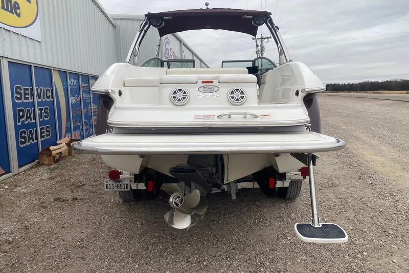 Slide: The Image of 2008 Cobalt 272 boat rear view at dealership, showcasing propeller and swim platform. - 4