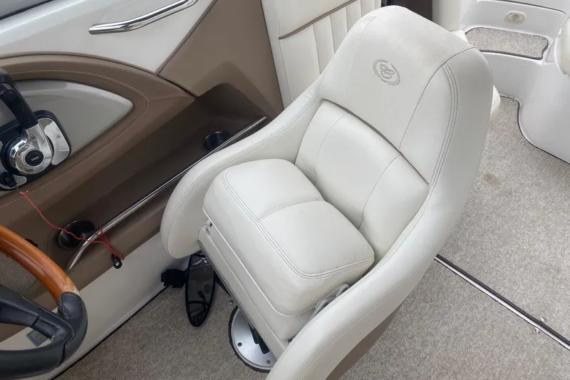 Slide: The Image of 2008 Cobalt 272 boat interior with white captain's chair and steering wheel. - 9