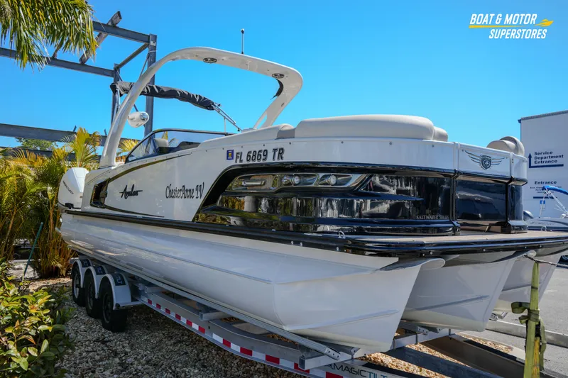 Slide: The Image of 2024 Avalon Twin Quad Lounger Windshield boat on trailer, outdoor display. - 13