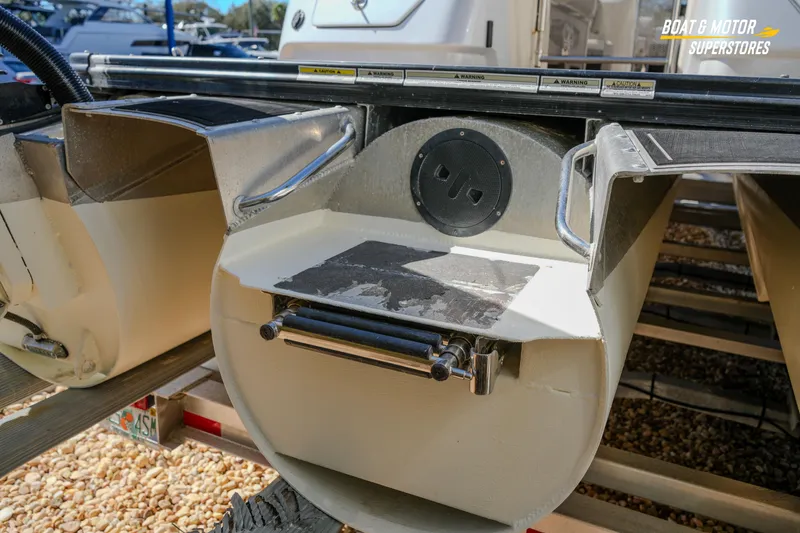 Slide: The Image of 2024 Avalon Twin Quad Lounger Windshield pontoon boat detail with speaker and ladder. - 16