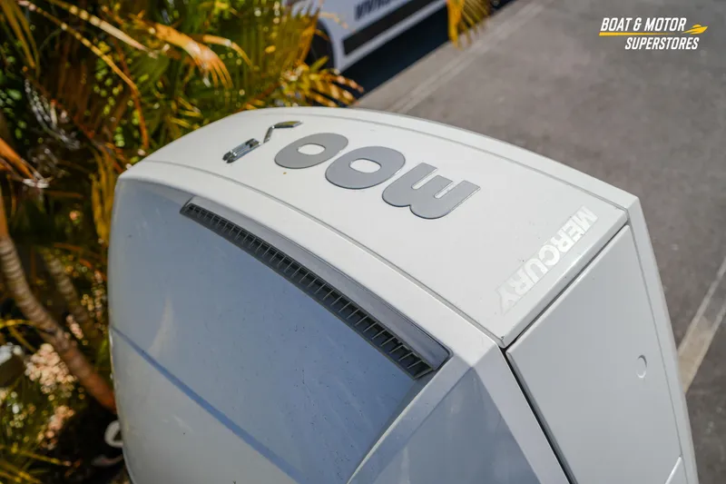 Slide: The Image of 2024 Avalon Twin Quad Lounger Windshield with Mercury outboard motor, outdoor setting. - 18