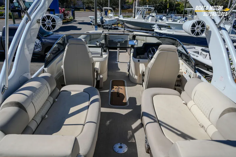 Slide: The Image of 2024 Avalon Twin Quad Lounger Windshield boat interior with plush seating and modern design. - 21