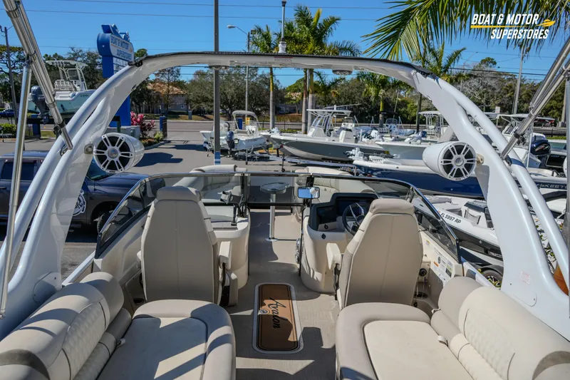 Slide: The Image of 2024 Avalon Twin Quad Lounger Windshield boat interior at dealership, featuring luxurious seating and modern design. - 22