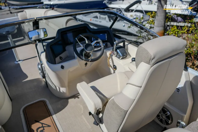 Slide: The Image of 2024 Avalon Twin Quad Lounger Windshield boat interior with steering wheel and dashboard. - 25