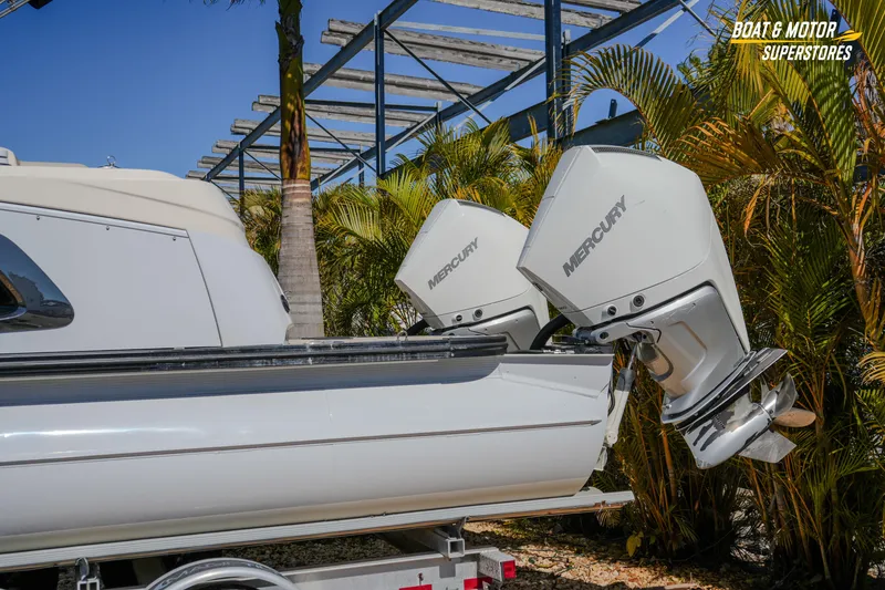 Slide: The Image of 2024 Avalon Twin Quad Lounger Windshield with dual Mercury outboard engines. - 3