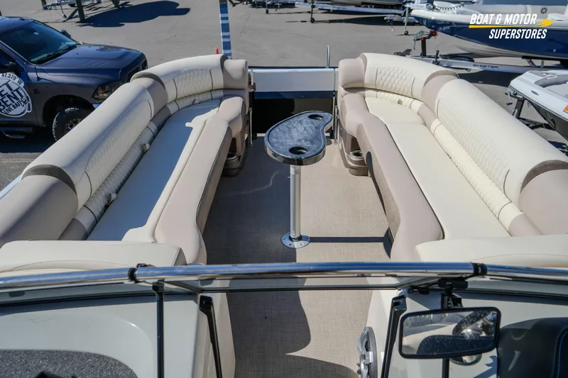 Slide: The Image of 2024 Avalon Twin Quad Lounger Windshield boat interior with luxurious seating and table. - 30