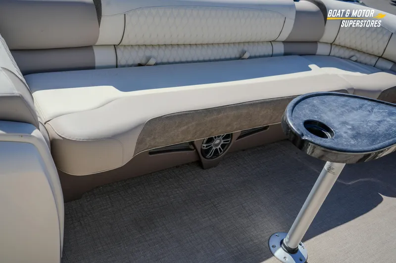 Slide: The Image of 2024 Avalon Twin Quad Lounger Windshield interior with plush seating and a sleek table. - 33
