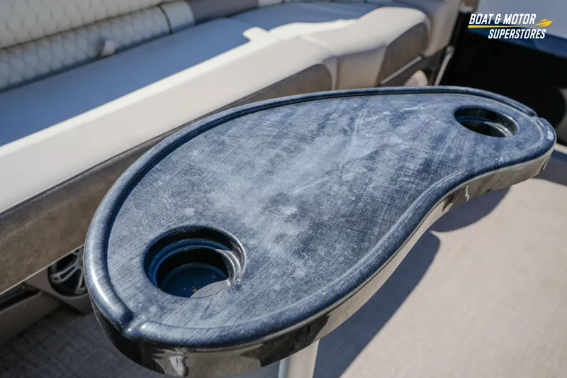 Slide: The Image of 2024 Avalon Twin Quad Lounger Windshield boat table with cup holders, interior view. - 34