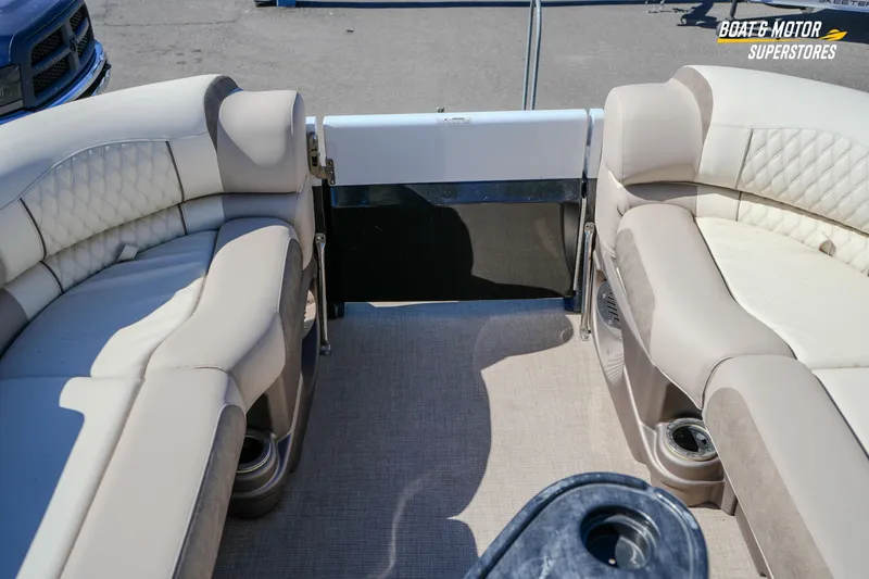 Slide: The Image of 2024 Avalon Twin Quad Lounger Windshield interior with beige seating and cup holders. - 35