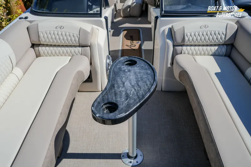 Slide: The Image of 2024 Avalon Twin Quad Lounger Windshield interior with luxurious seating and table. - 36