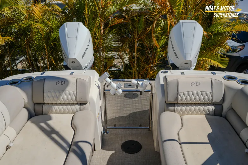 Slide: The Image of 2024 Avalon Twin Quad Lounger Windshield boat interior with dual Mercury engines. - 40