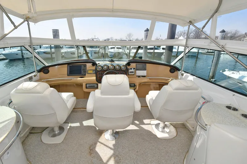 Slide: The Image of Interior of 2001 Carver 466 Motor Yacht with helm and seating, docked at marina. - 17