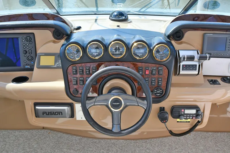 Slide: The Image of 2001 Carver 466 Motor Yacht helm with steering wheel, gauges, and navigation equipment. - 19