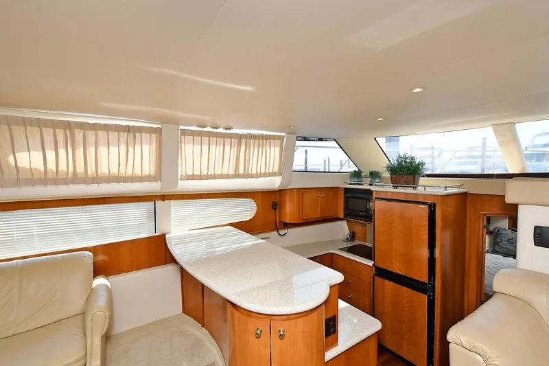 Slide: The Image of Luxurious interior of 2001 Carver 466 Motor Yacht with modern kitchen and seating area. - 25