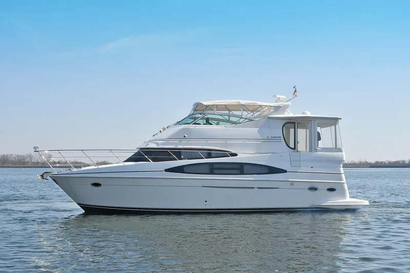 Slide: The Image of 2001 Carver 466 Motor Yacht on calm water under clear blue sky. - 3