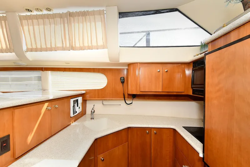 Slide: The Image of Interior of 2001 Carver 466 Motor Yacht kitchen with wood cabinets and modern appliances. - 31
