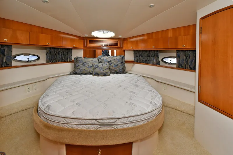 Slide: The Image of Interior of 2001 Carver 466 Motor Yacht bedroom with bed and wooden cabinetry. - 32