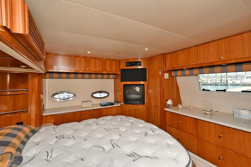 Slide: The Image of Luxurious cabin interior of 2001 Carver 466 Motor Yacht with wood finish and cozy bed. - 38