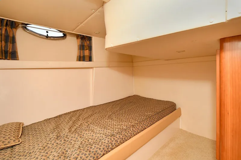 Slide: The Image of 2001 Carver 466 Motor Yacht cabin with single bed and porthole window. - 40