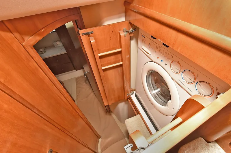 Slide: The Image of Laundry area inside 2001 Carver 466 Motor Yacht with wood cabinetry. - 42