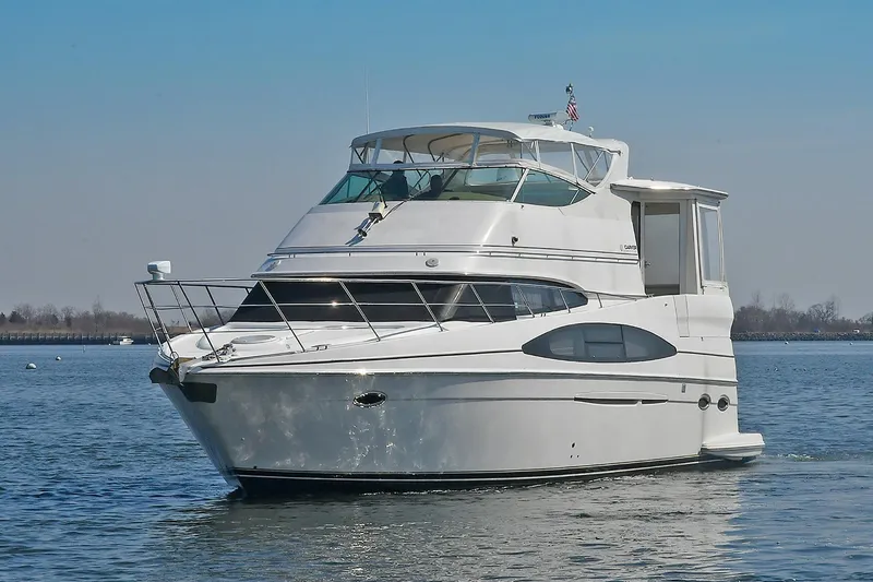 Slide: The Image of 2001 Carver 466 Motor Yacht on calm water, showcasing sleek design and spacious deck. - 6