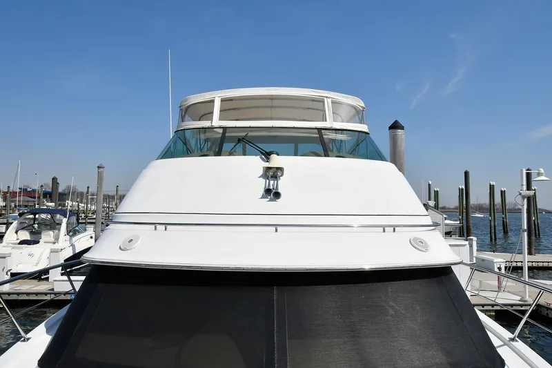 Slide: The Image of 2001 Carver 466 Motor Yacht docked at marina under clear blue sky. - 7