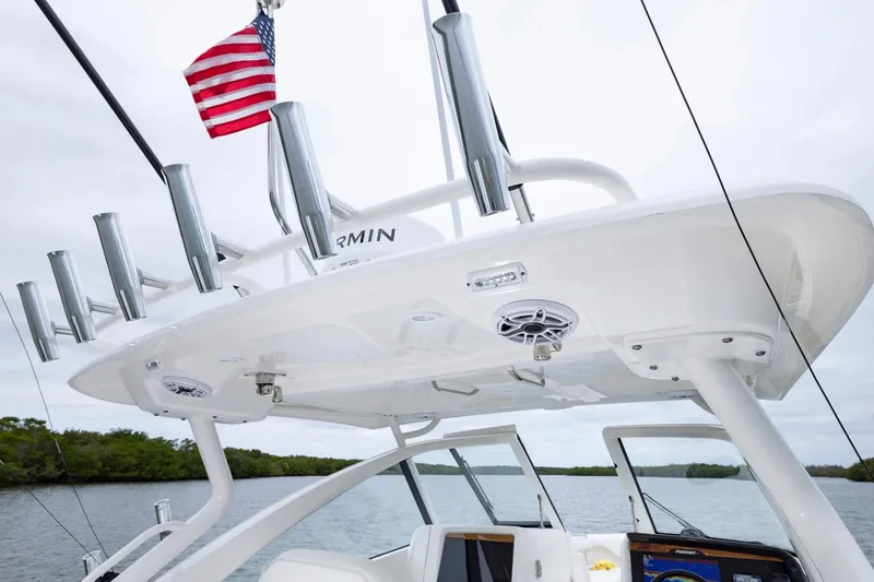 Slide: The Image of 2026 Pursuit DC 286 Dual Console boat with rod holders and American flag. - 10