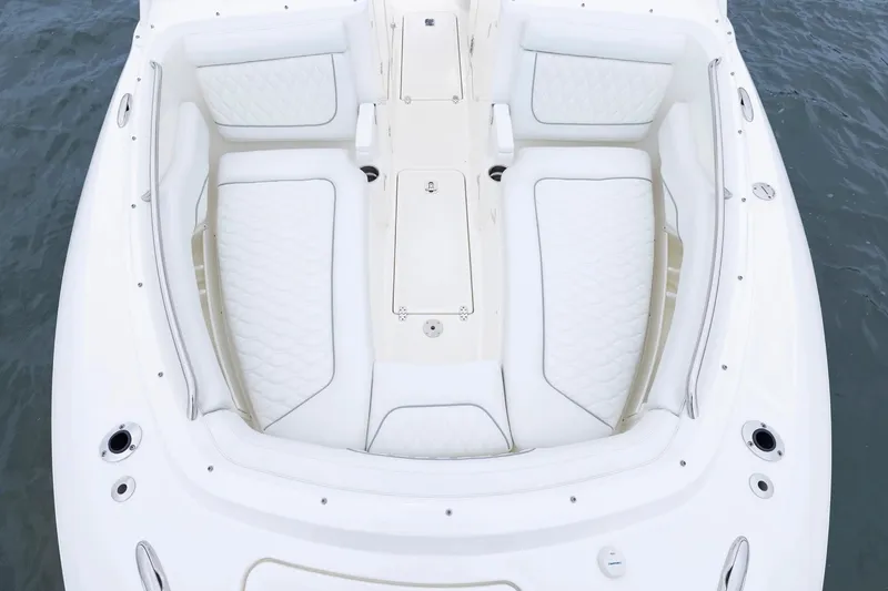 Slide: The Image of 2026 Pursuit DC 286 Dual Console boat with luxurious white seating on water. - 15