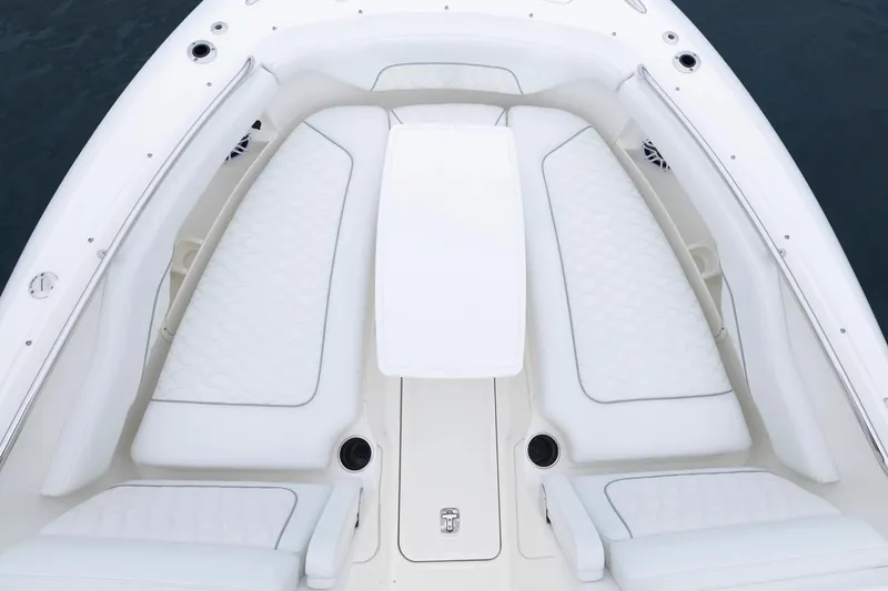 Slide: The Image of 2026 Pursuit DC 286 Dual Console boat with white cushioned seating and sleek design. - 16