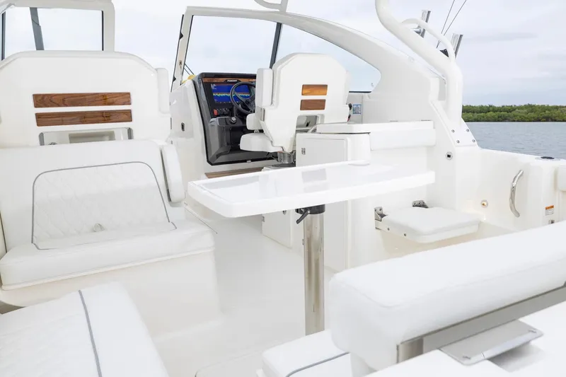 Slide: The Image of 2026 Pursuit DC 286 Dual Console interior with white seating and sleek design. - 5