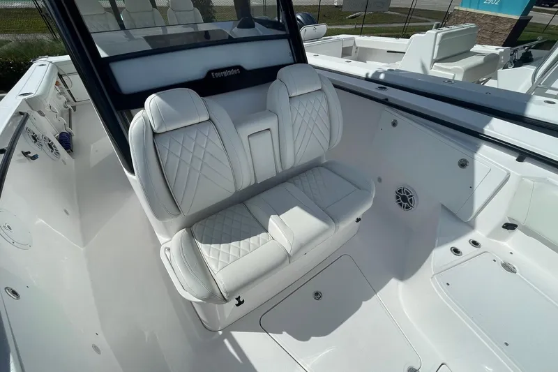 Slide: The Image of 2022 Everglades 335 Center Console boat with luxurious white seating and modern design. - 14