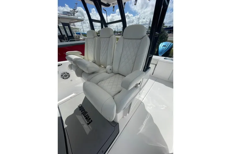 Slide: The Image of Luxurious seating on 2022 Everglades 335 Center Console boat, featuring white quilted upholstery. - 17