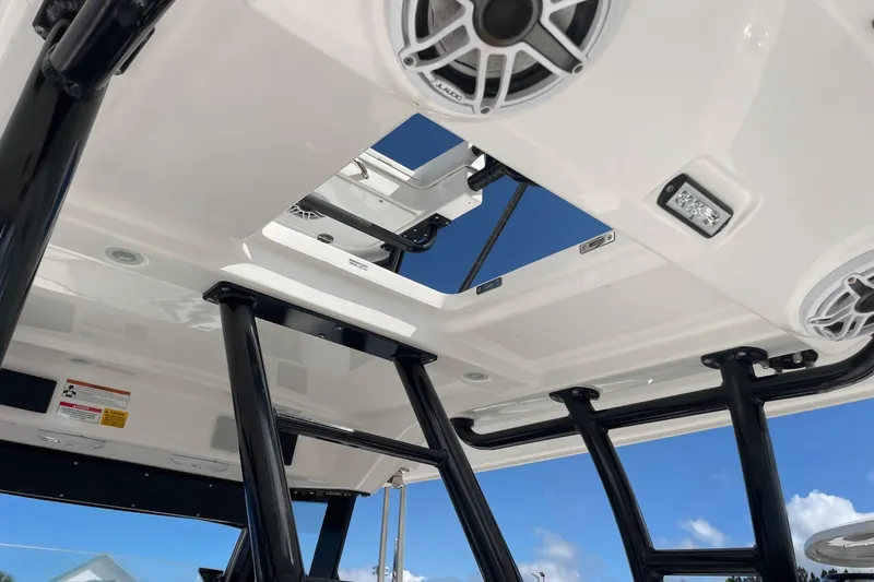 Slide: The Image of 2022 Everglades 335 Center Console boat roof with speakers and lighting fixtures. - 21